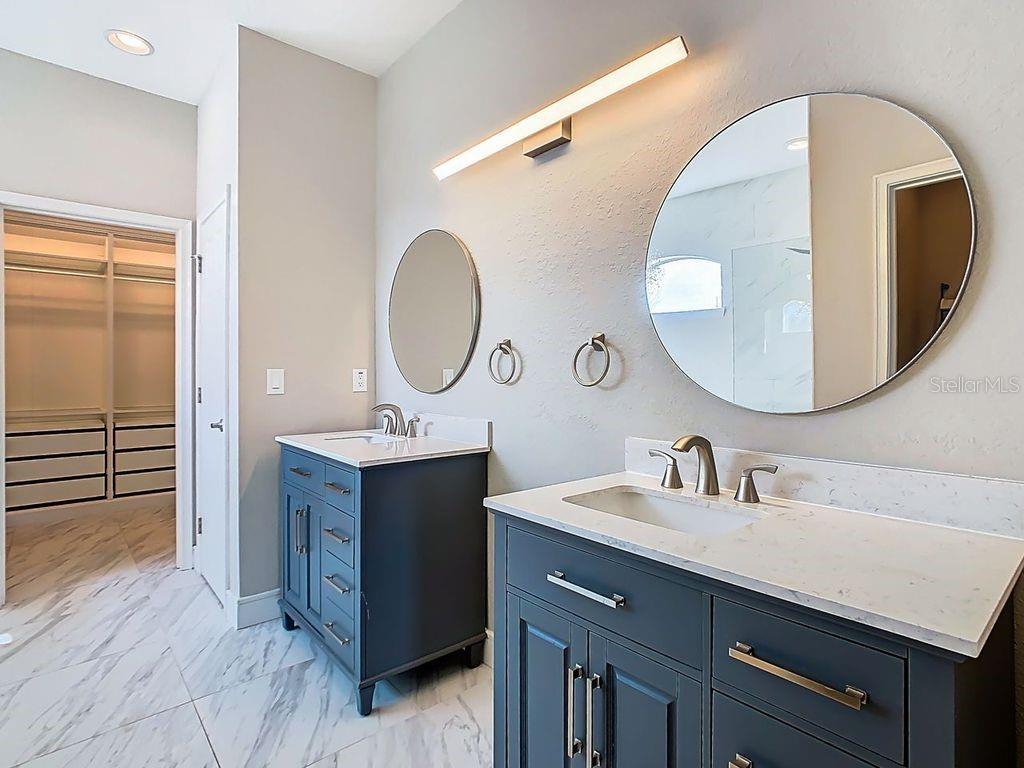 1918 Berry Road Plant City, FL 33567 - Photo 32 of 53 a bathroom with a double vanity sink mirror and shower