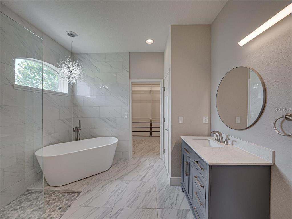 1918 Berry Road Plant City, FL 33567 - Photo 33 of 53 a bathroom with a double vanity sink a mirror and a bathtub