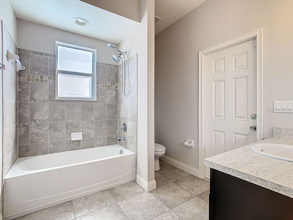 1918 Berry Road Plant City, FL 33567 - Photo 36 of 53 a spacious bathroom with a bathtub and a toilet