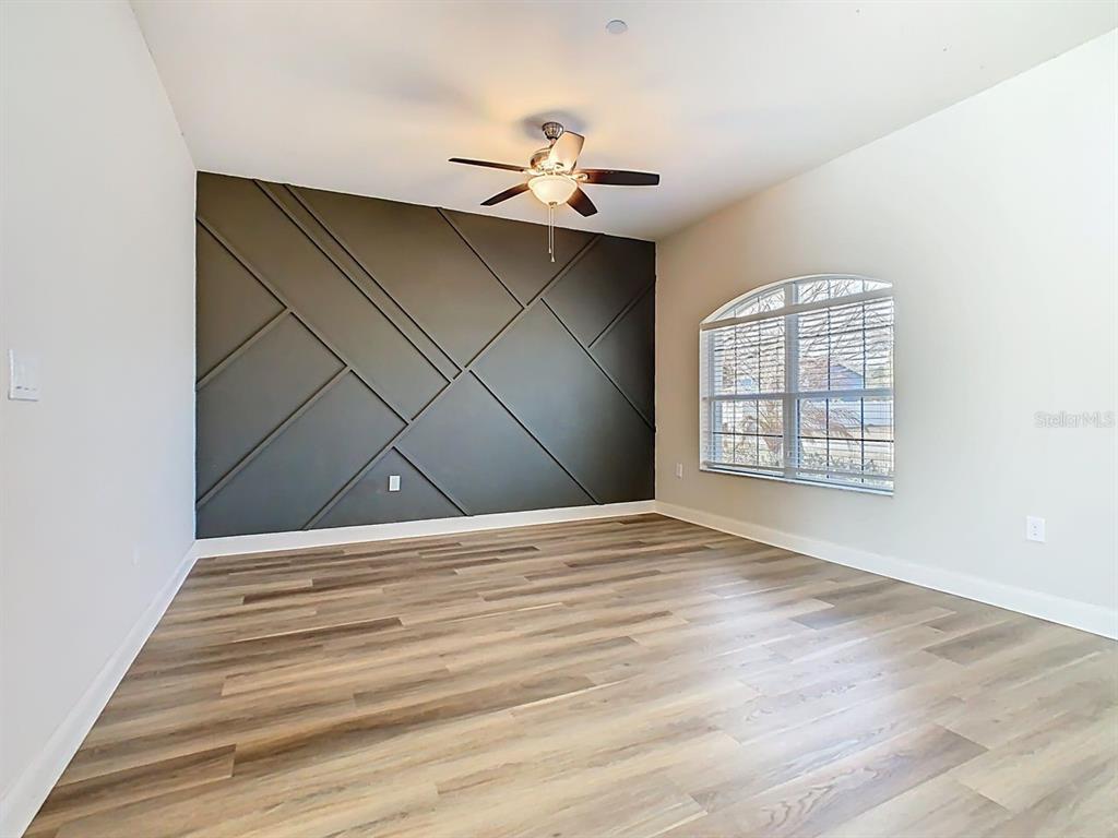 1918 Berry Road Plant City, FL 33567 - Photo 5 of 53 a view of an empty room with wooden floor and a window
