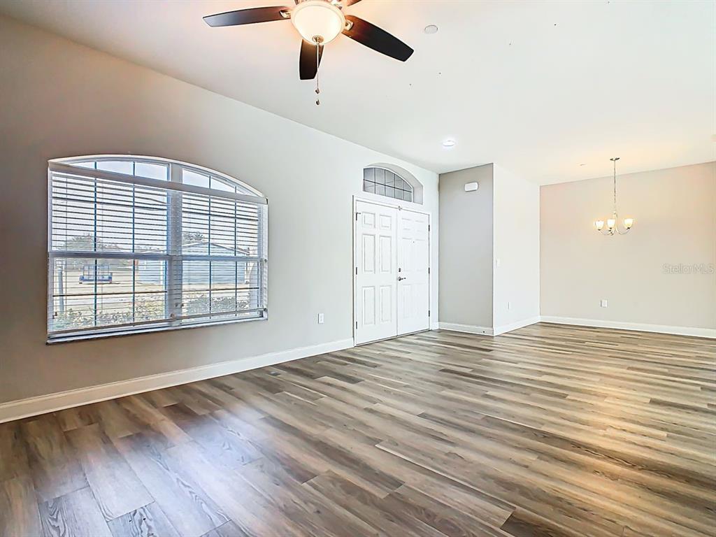 1918 Berry Road Plant City, FL 33567 - Photo 6 of 53 a view of empty room with wooden floor and fan