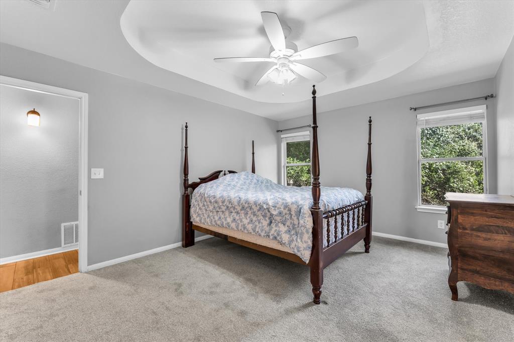7 Market Loop Morgan's Point Resort, TX 76513 - Photo 13 of 31 Carpeted bedroom featuring a ceiling fan and two windows.