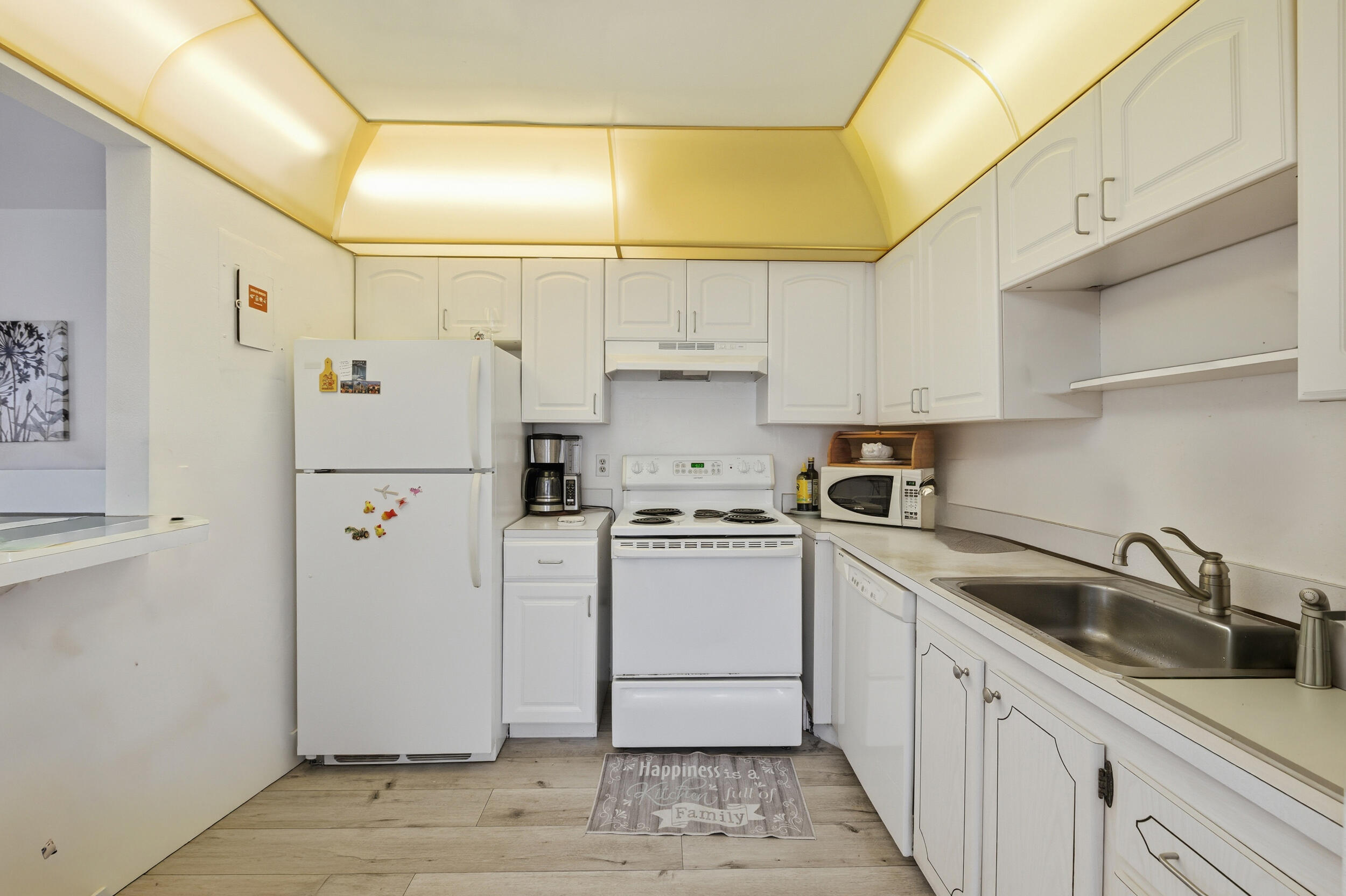 374 Tuscany Lane, Unit G Delray Beach, FL 33446 - Photo 17 of 21 a kitchen with white cabinets and white appliances