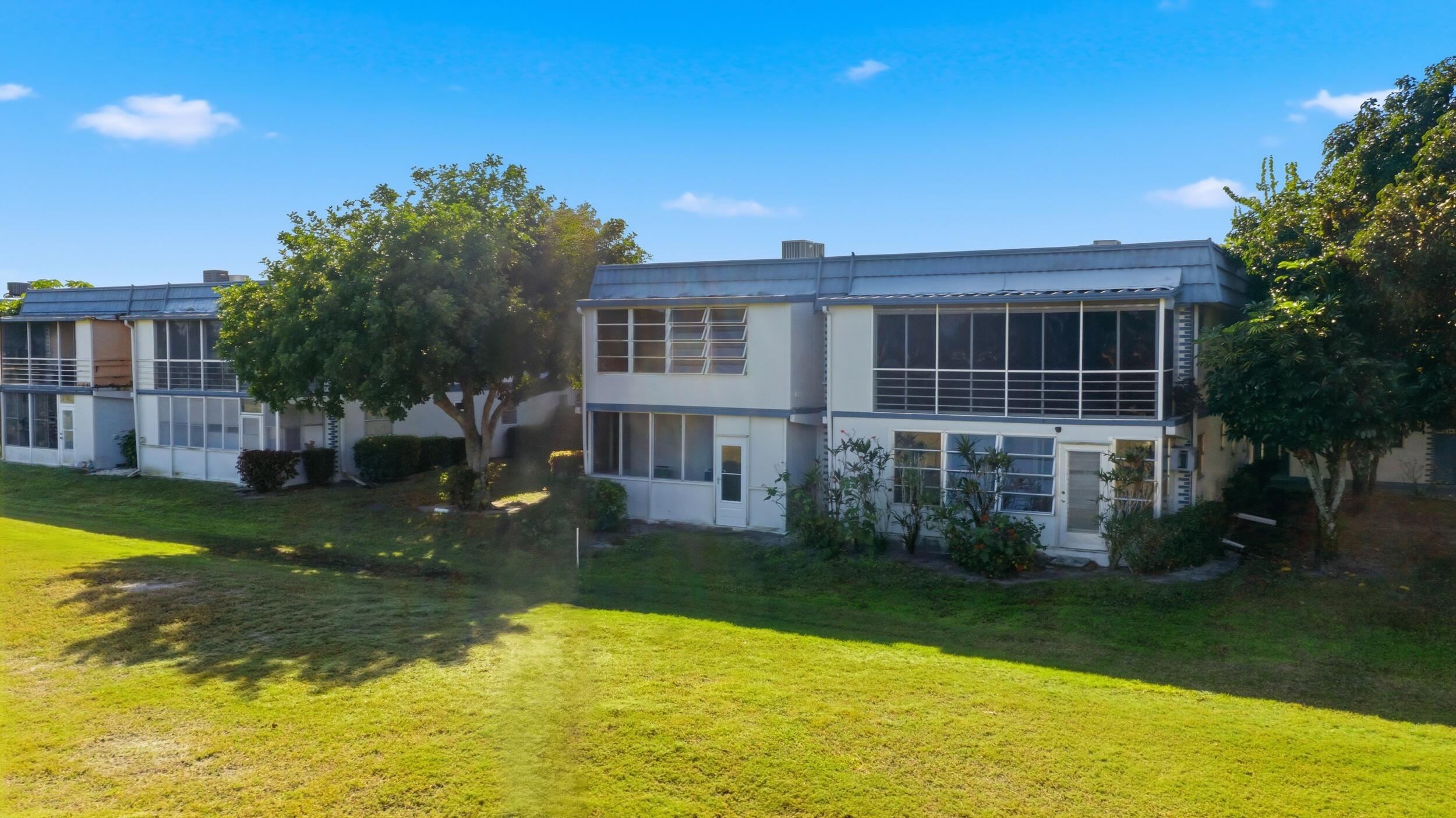 374 Tuscany Lane, Unit G Delray Beach, FL 33446 - Photo 4 of 21 a view of a house with a yard