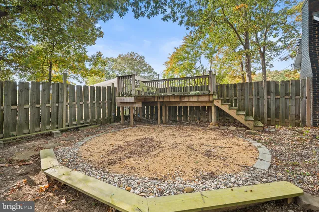 a view of a backyard with a wooden fence