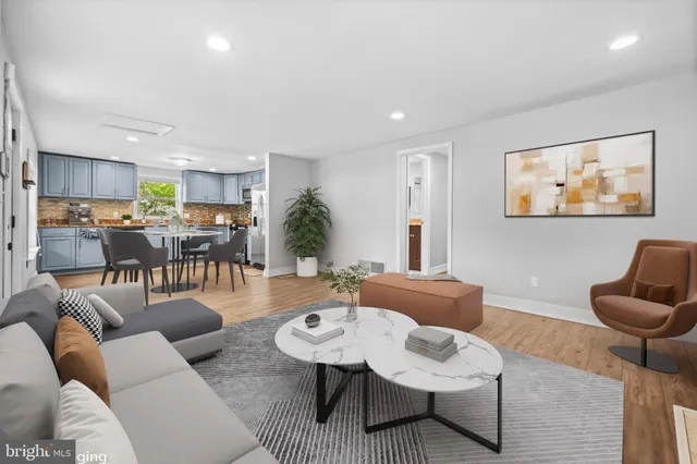 a living room with furniture kitchen view and a table
