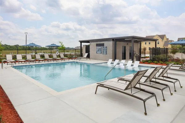 a view of swimming pool with outdoor seating and city view