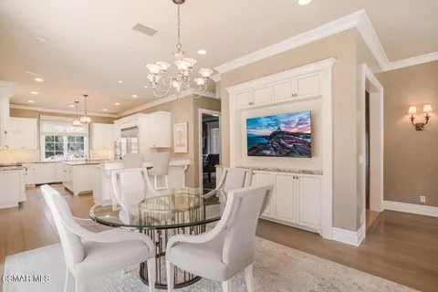 a view of a dining room with furniture wooden floor and chandelier