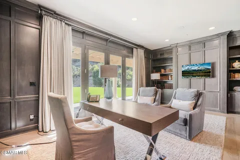 a living room with furniture a rug and a large window