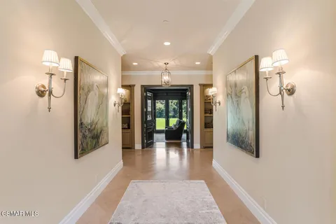 a view of a hallway with wooden floor and glass door