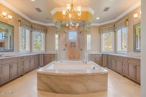 a large bathroom with a large tub shower and sink