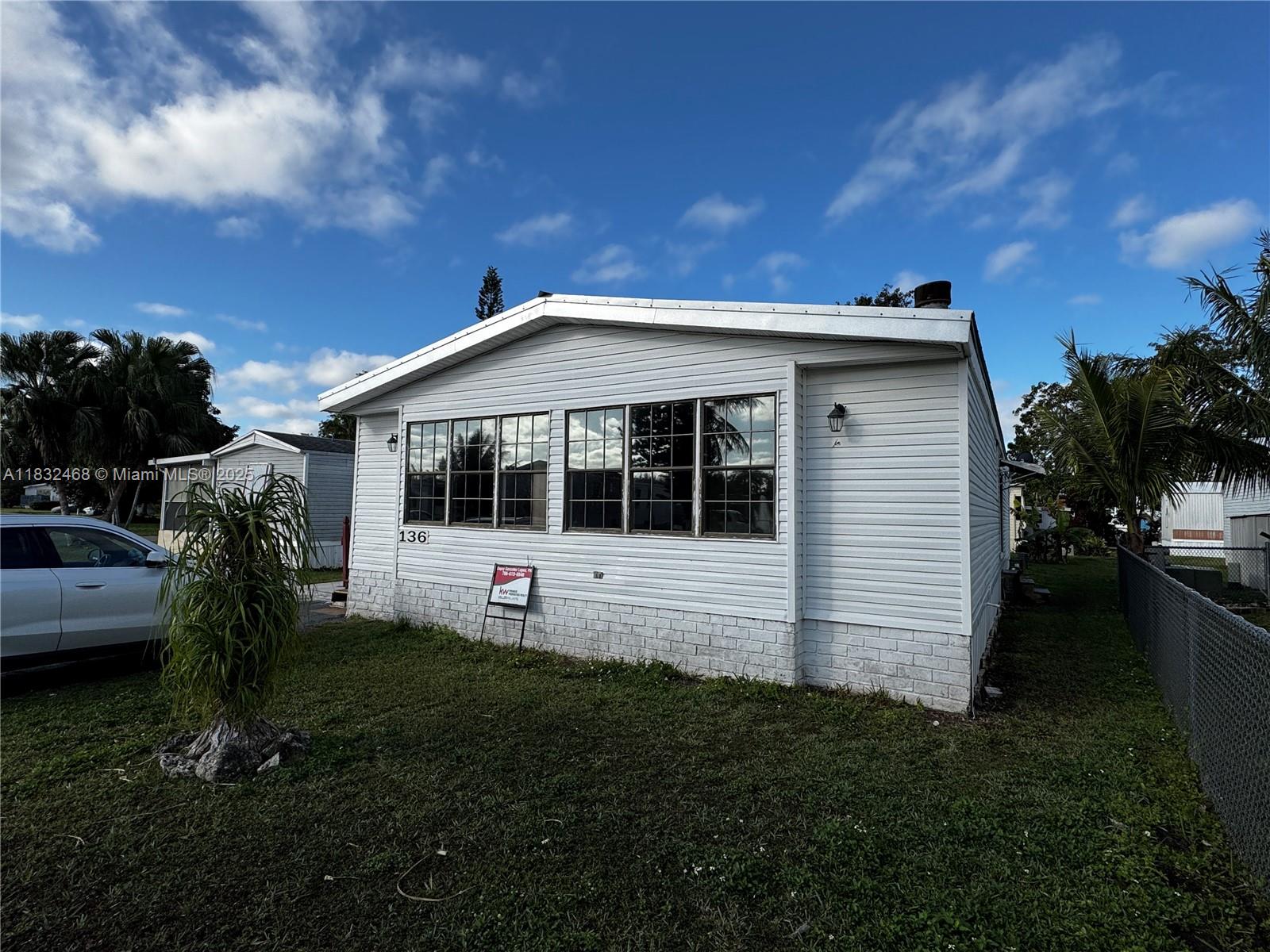 a view of house with backyard and garden