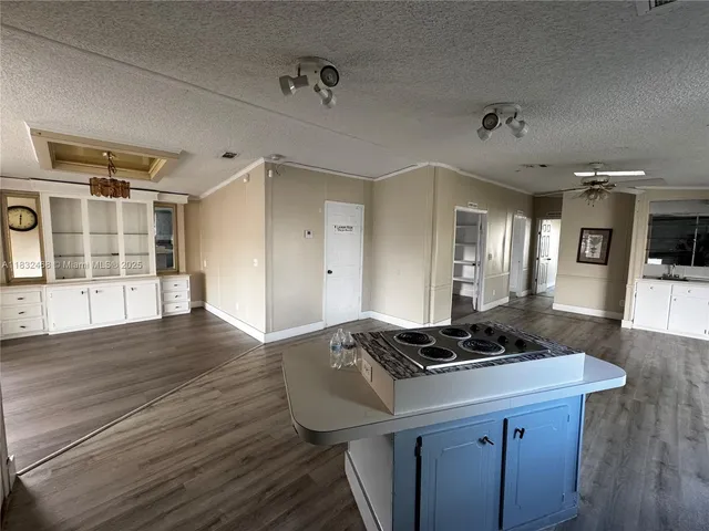 a kitchen with a sink and wooden floor
