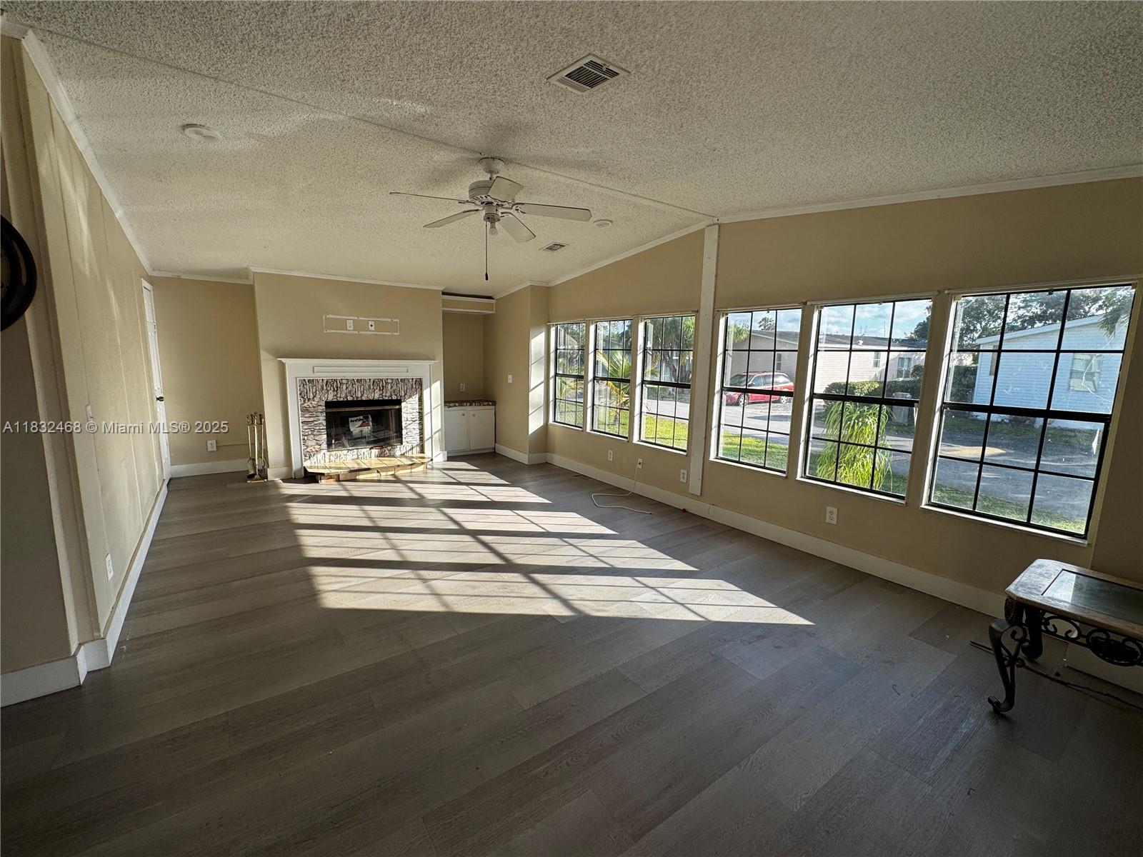 35250 Southwest 177th Court, Unit 136 Homestead, FL 33034 - Photo 17 of 18 a living room with furniture and a fireplace