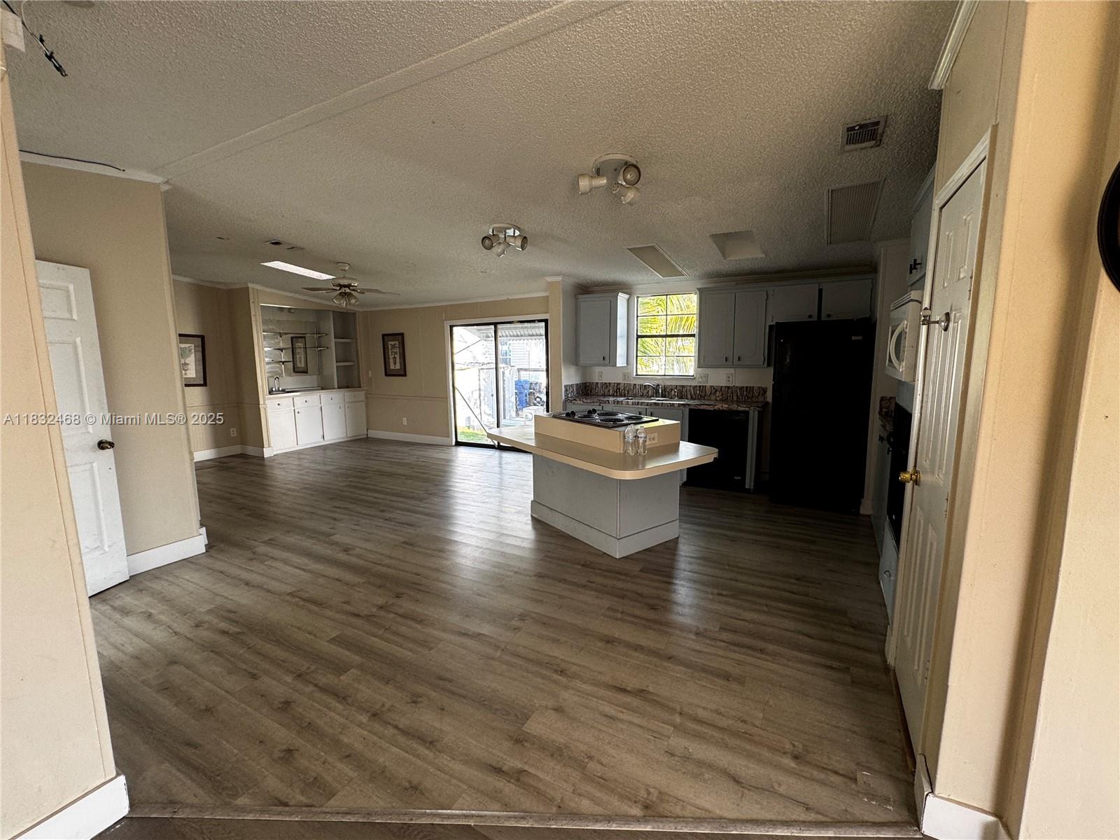 35250 Southwest 177th Court, Unit 136 Homestead, FL 33034 - Photo 18 of 18 a living room with stainless steel appliances furniture a refrigerator and a view of kitchen