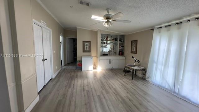 35250 Southwest 177th Court, Unit 136 Homestead, FL 33034 - Photo 8 of 18 a view of a livingroom with hardwood floor and a ceiling fan