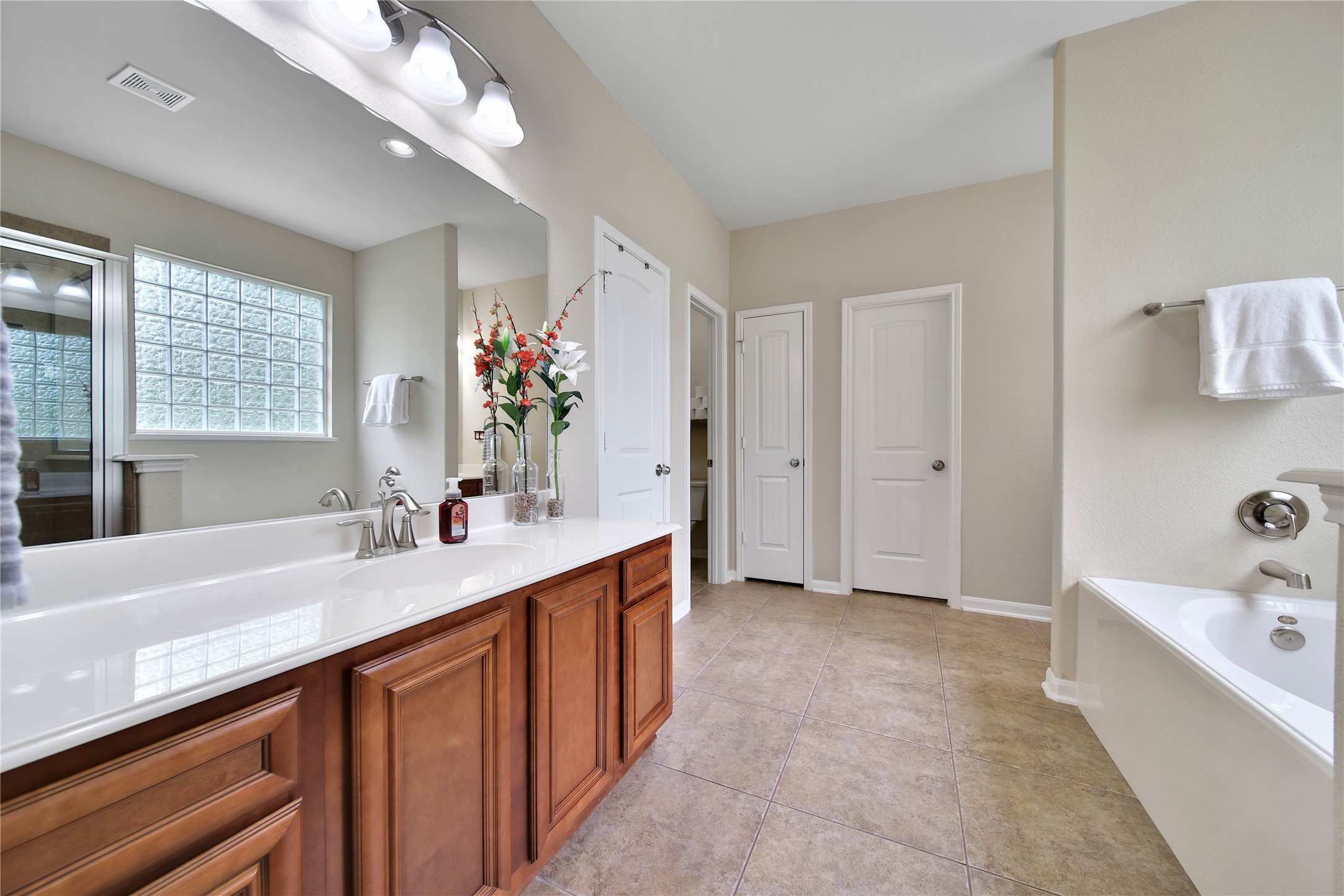 9223 Wapiti Trail Conroe, TX 77303 - Photo 26 of 45 a bathroom with a sink double vanity granite tub shower and a mirror