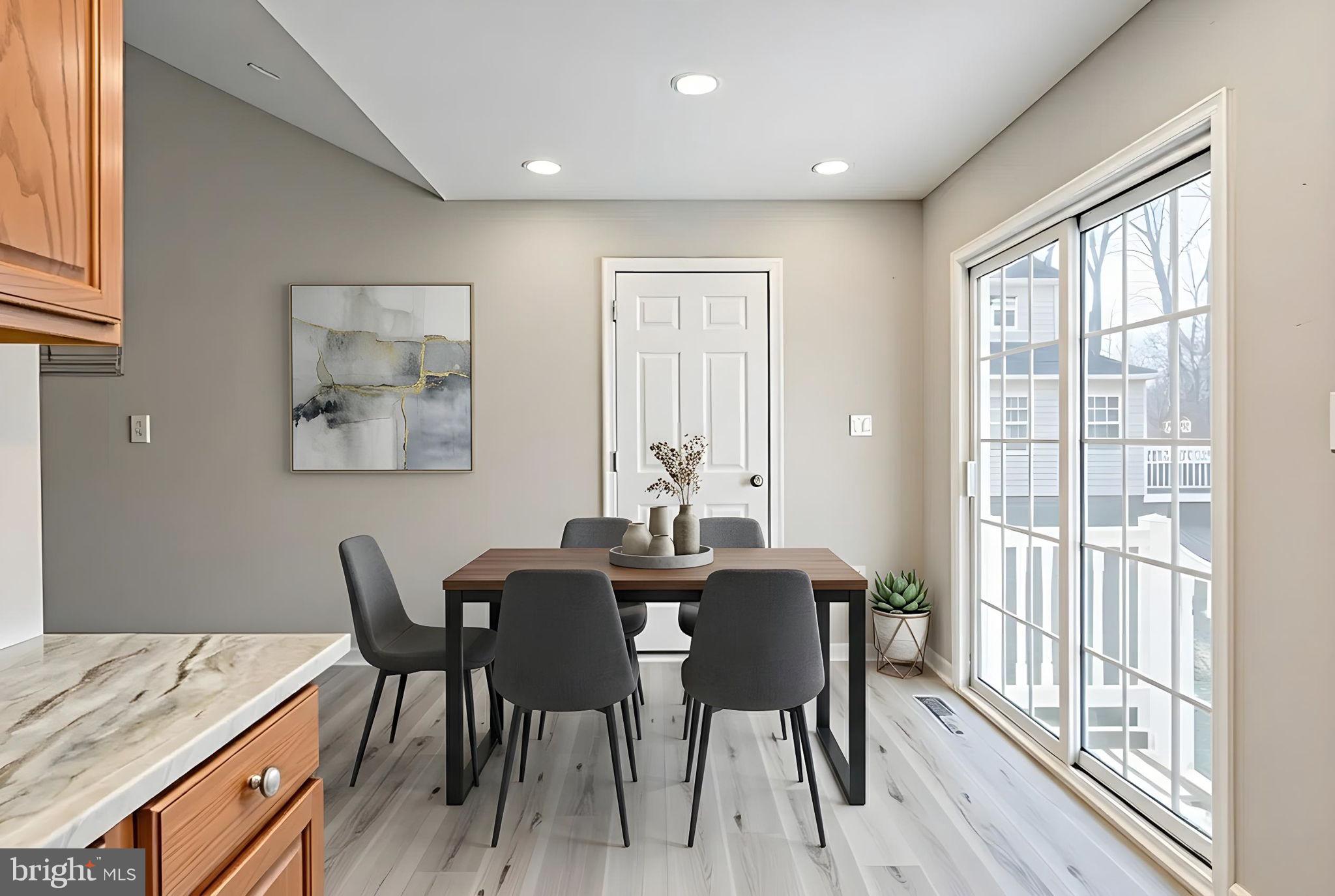 219 Santa Maria Avenue Colonial Beach, VA 22443 - Photo 11 of 52 a dining room with furniture and wooden floor
