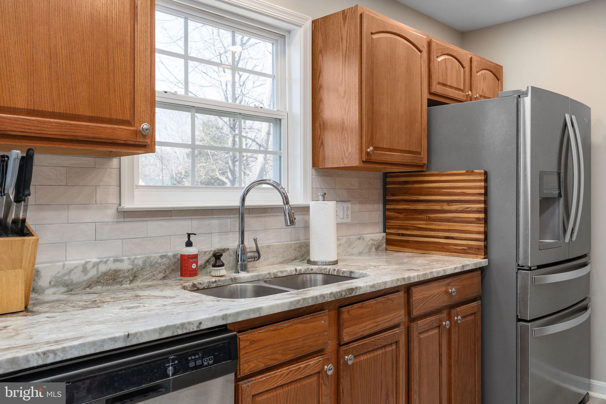 219 Santa Maria Avenue Colonial Beach, VA 22443 - Photo 14 of 52 a kitchen with granite countertop a sink and a refrigerator