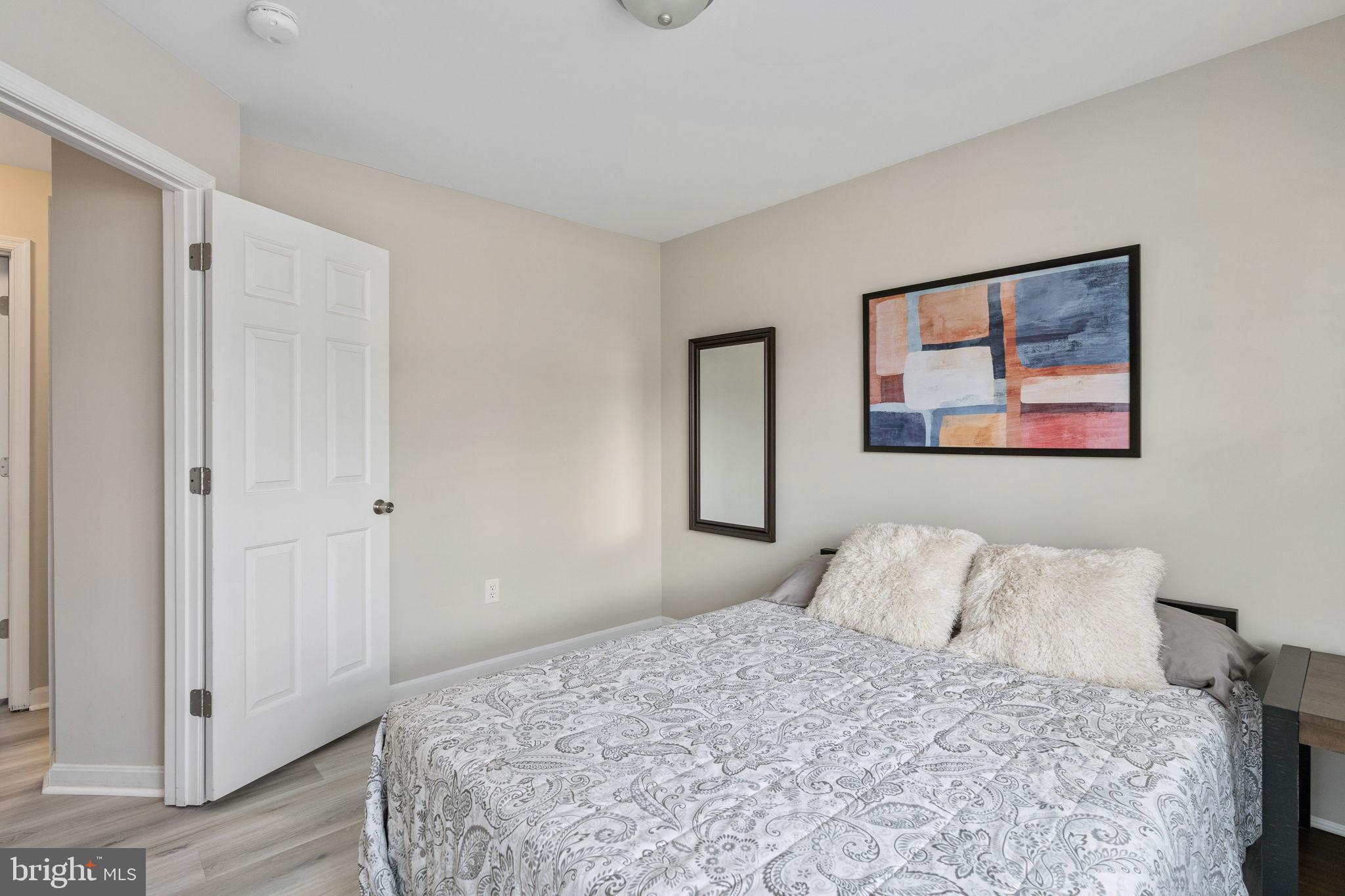 219 Santa Maria Avenue Colonial Beach, VA 22443 - Photo 25 of 52 a bedroom with a bed and a painting on the wall