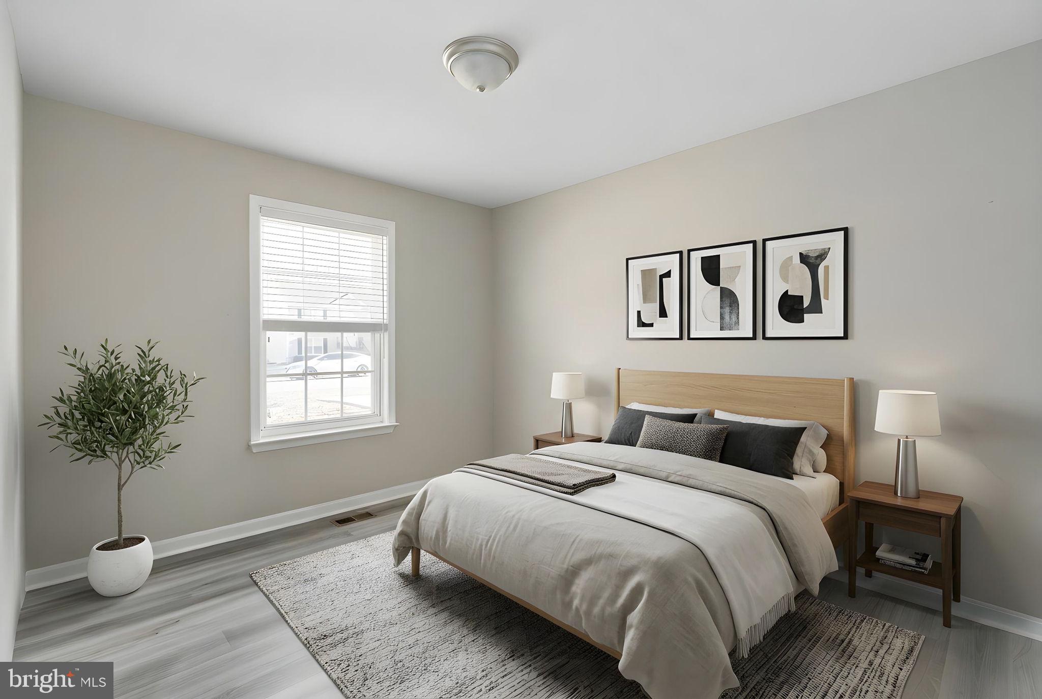 219 Santa Maria Avenue Colonial Beach, VA 22443 - Photo 29 of 52 a bedroom with bed and a potted plant
