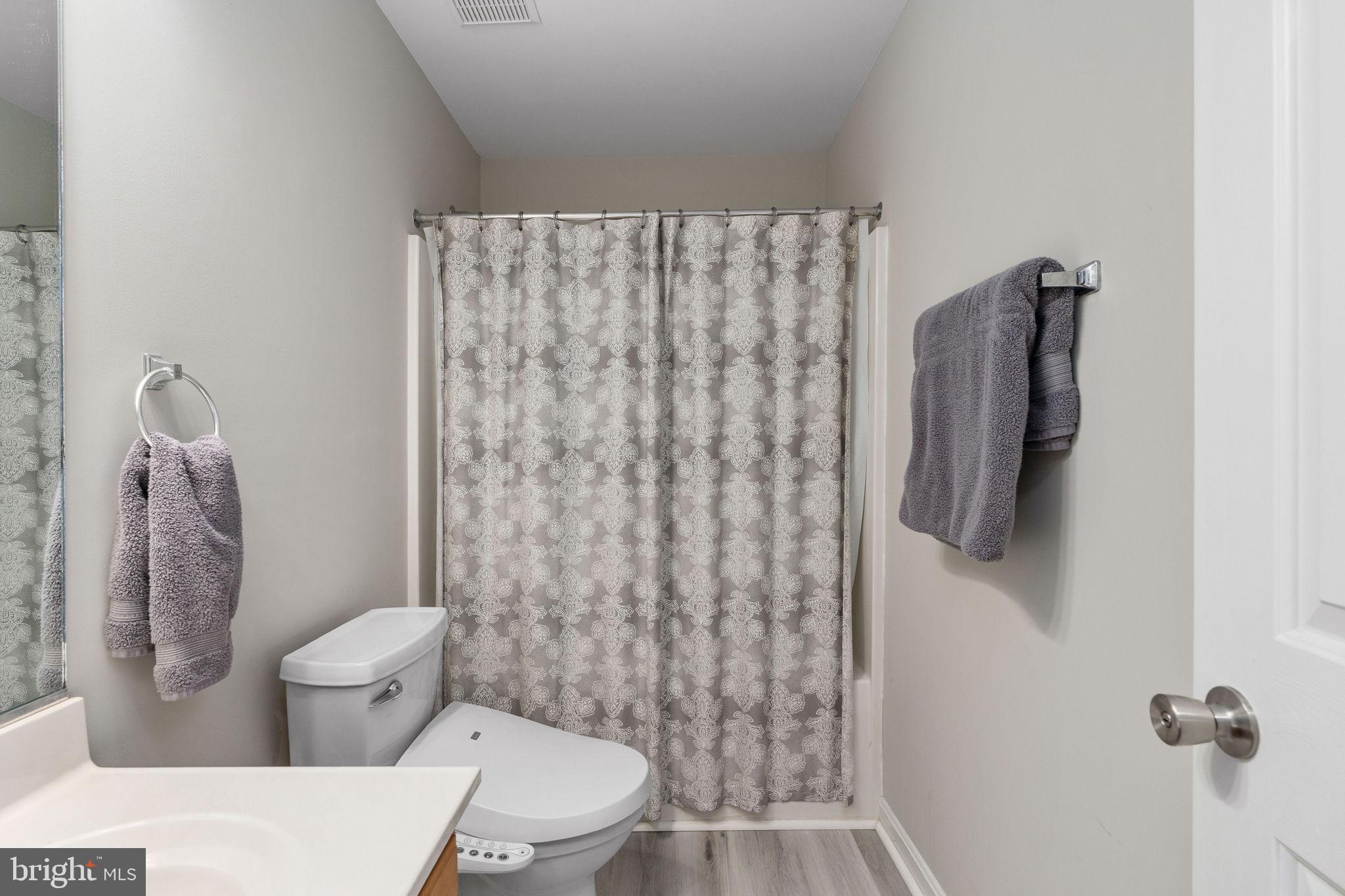 219 Santa Maria Avenue Colonial Beach, VA 22443 - Photo 30 of 52 a white toilet sitting next to a shower curtain