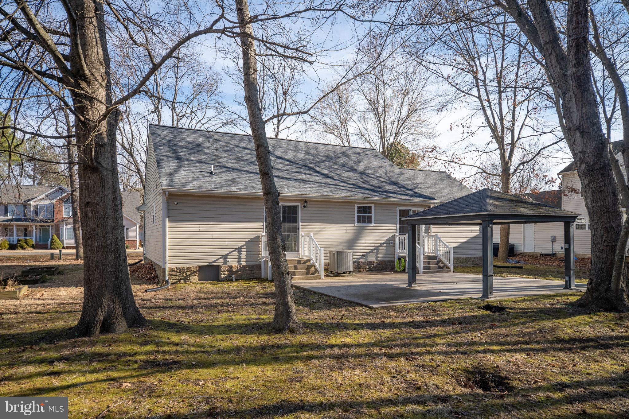 219 Santa Maria Avenue Colonial Beach, VA 22443 - Photo 37 of 52 a view of a house with large trees and sitting area