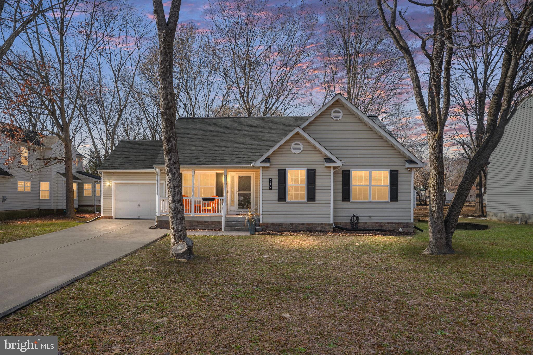 219 Santa Maria Avenue Colonial Beach, VA 22443 - Photo 51 of 52 a front view of a house with a yard and garage
