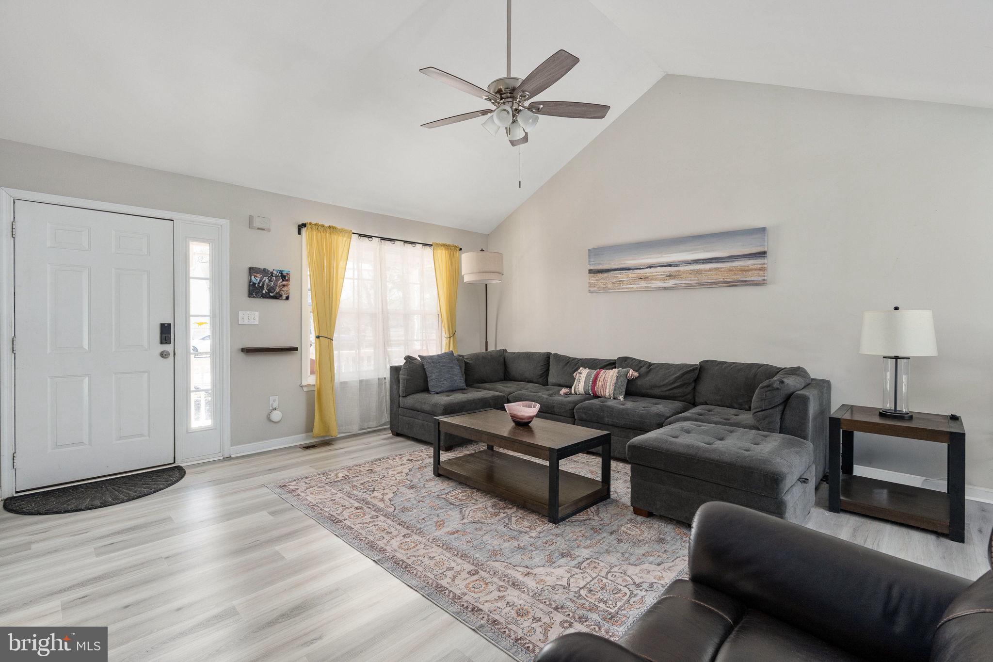 219 Santa Maria Avenue Colonial Beach, VA 22443 - Photo 6 of 52 a living room with furniture and a large window with wooden floor