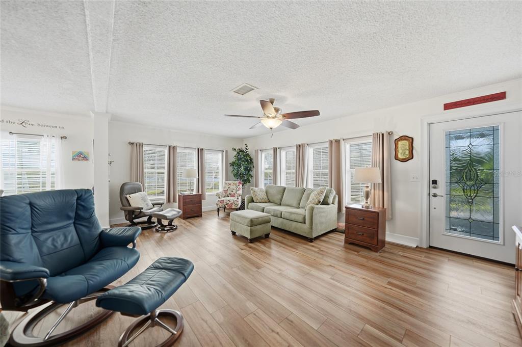 10303 Burnt Store Road, Unit 143 Punta Gorda, FL 33950 - Photo 11 of 42 a living room with furniture and a large window