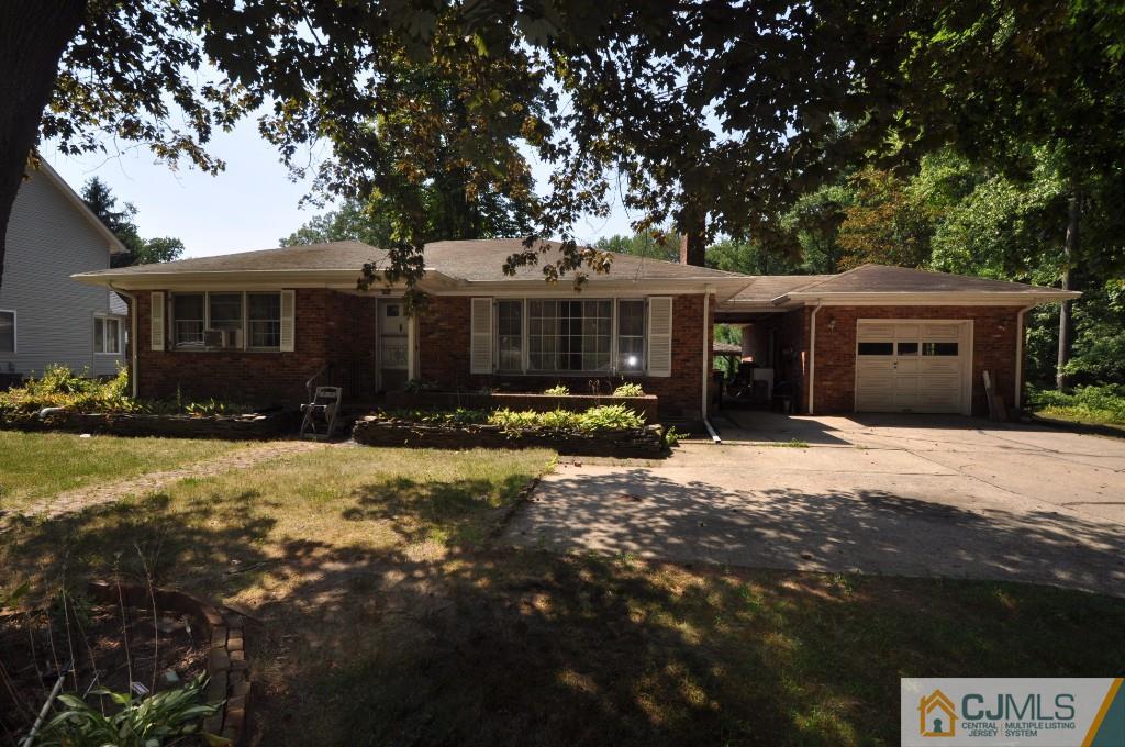 1553 Englishtown Road Old Bridge, NJ 08857 - Photo 1 of 1 a front view of a house with a yard and garage
