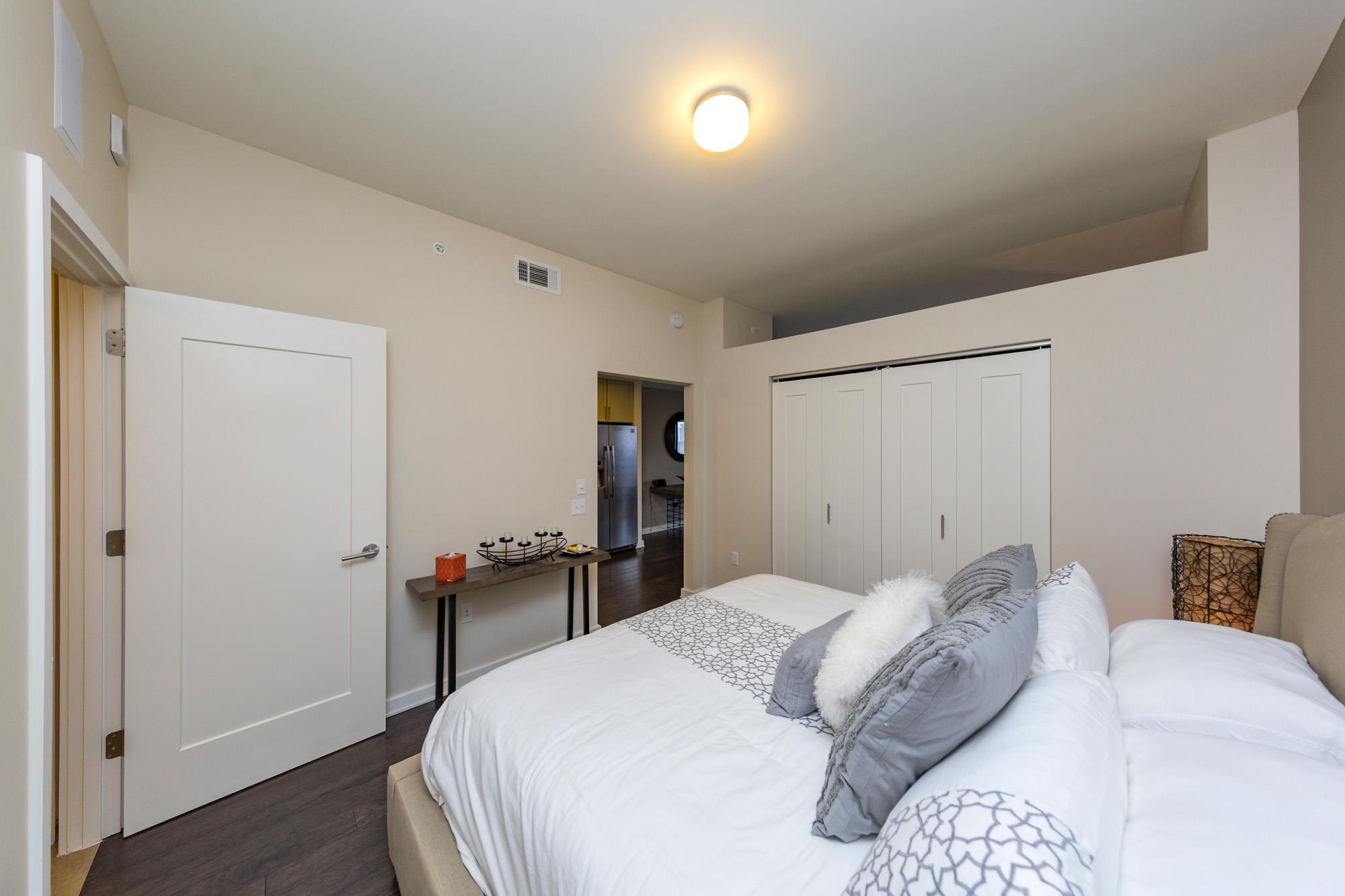 1212 Laurel Street, Unit 1312 Nashville, TN 37203 - Photo 14 of 22 a bedroom with a bed and a table in it