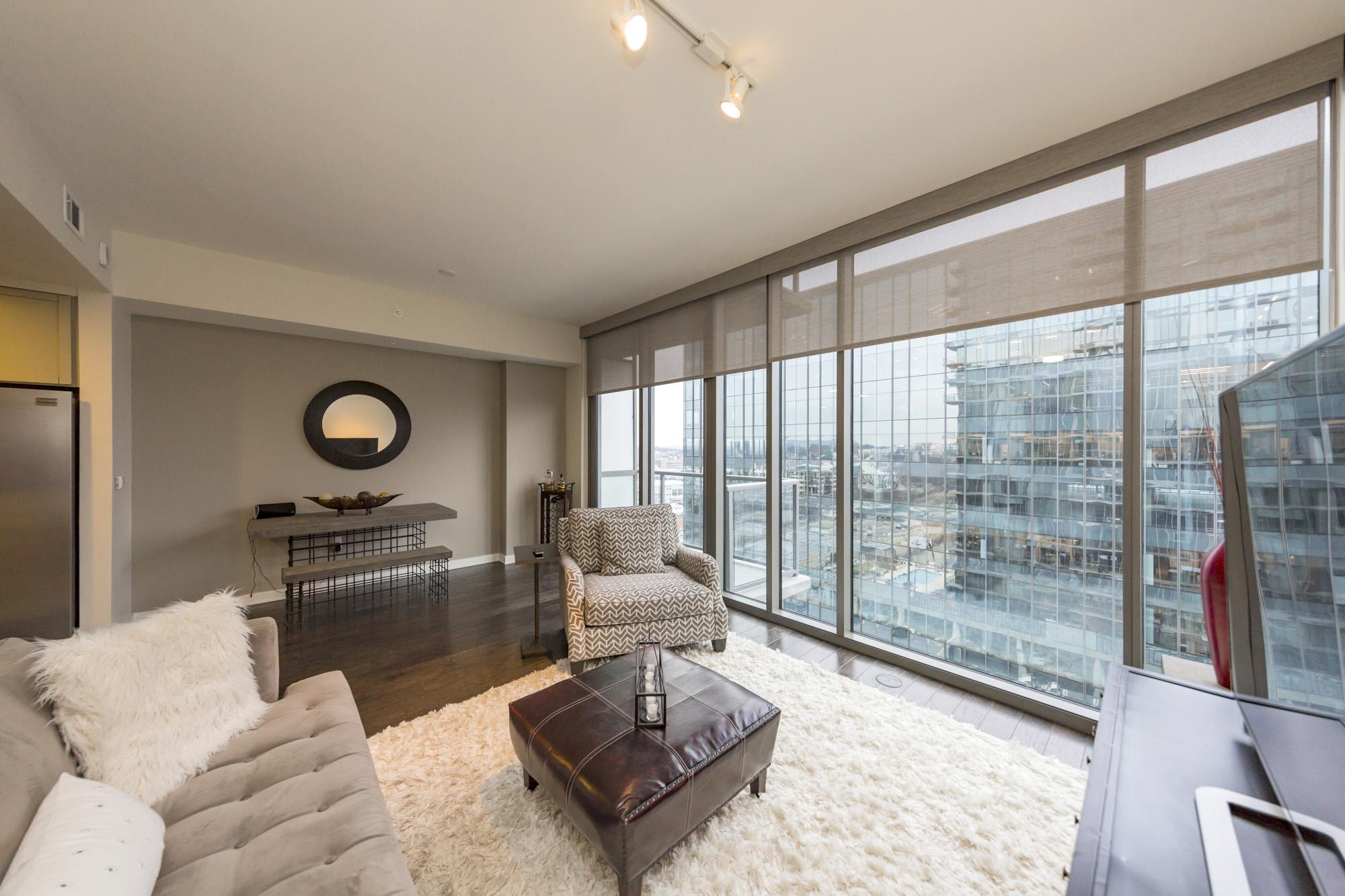 1212 Laurel Street, Unit 1312 Nashville, TN 37203 - Photo 3 of 22 a living room with furniture a rug and a floor to ceiling window