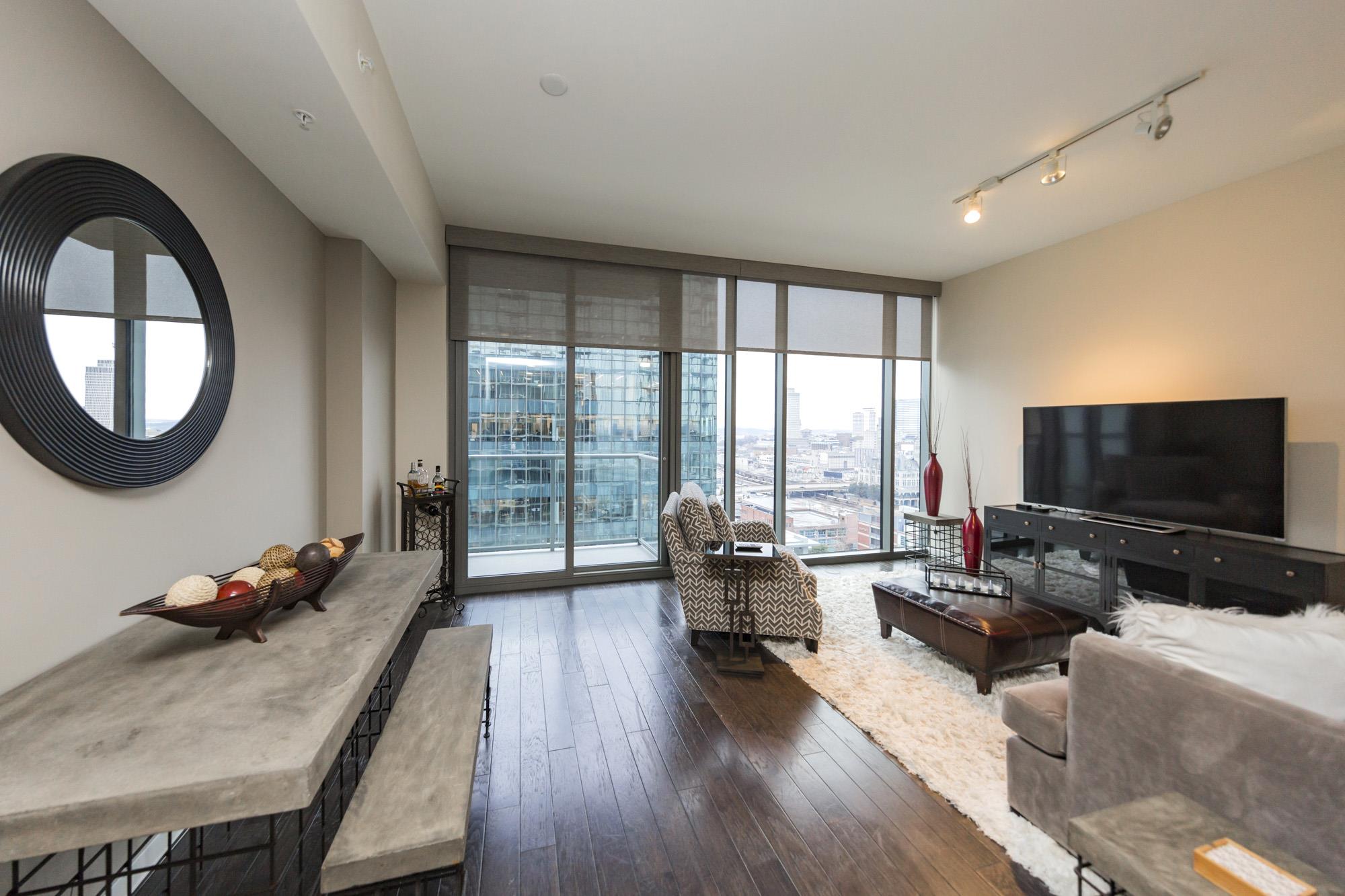 1212 Laurel Street, Unit 1312 Nashville, TN 37203 - Photo 5 of 22 a living room with furniture and a flat screen tv