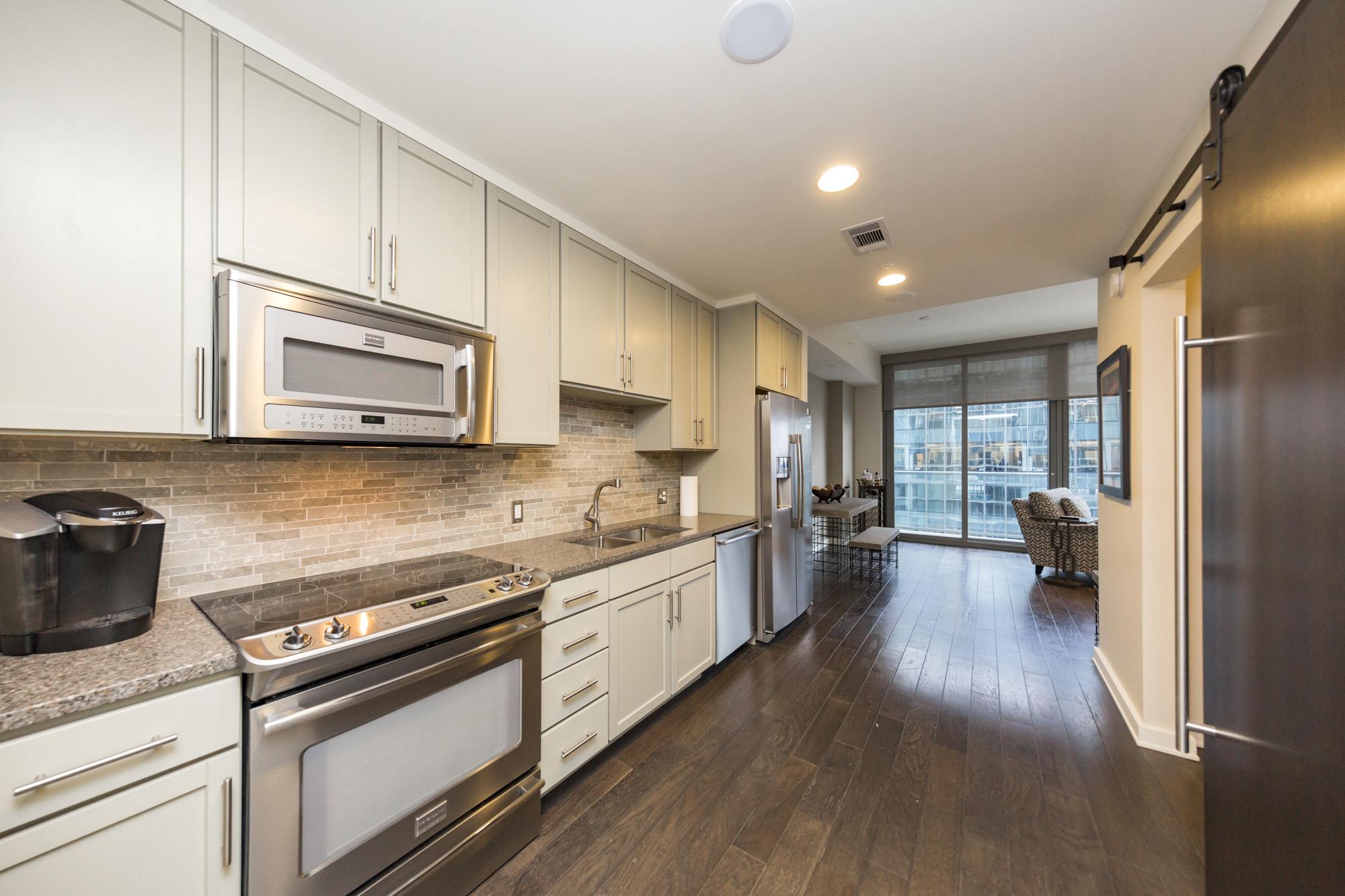 1212 Laurel Street, Unit 1312 Nashville, TN 37203 - Photo 10 of 22 a kitchen with sink stove and cabinets