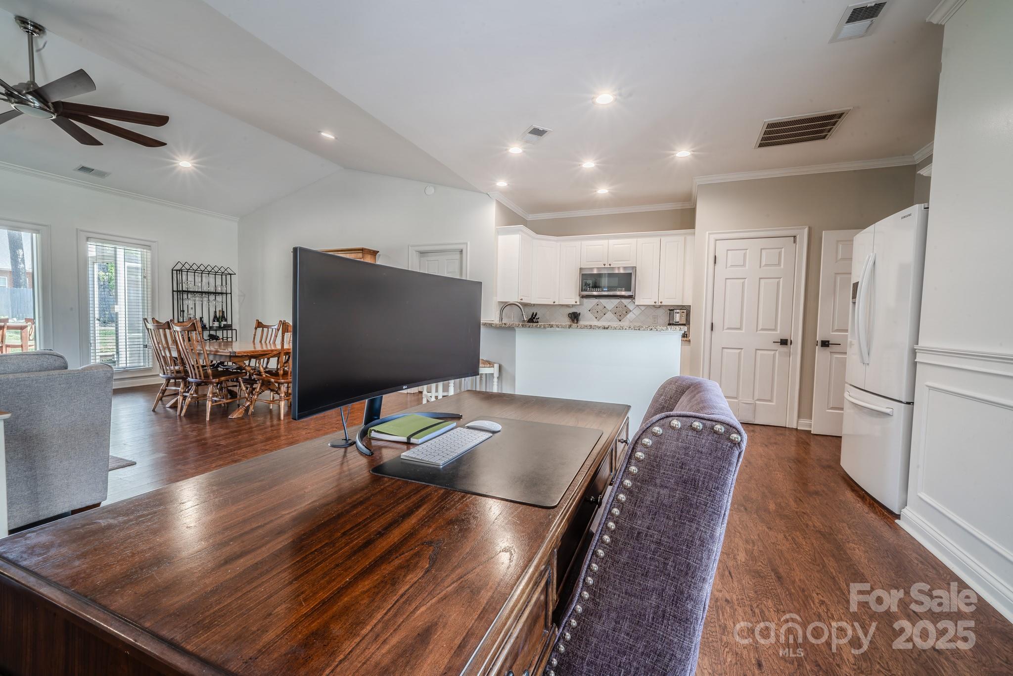 8271 Camelia Lane Denver, NC 28037 - Photo 13 of 27 a living room with stainless steel appliances furniture a rug and a flat screen tv