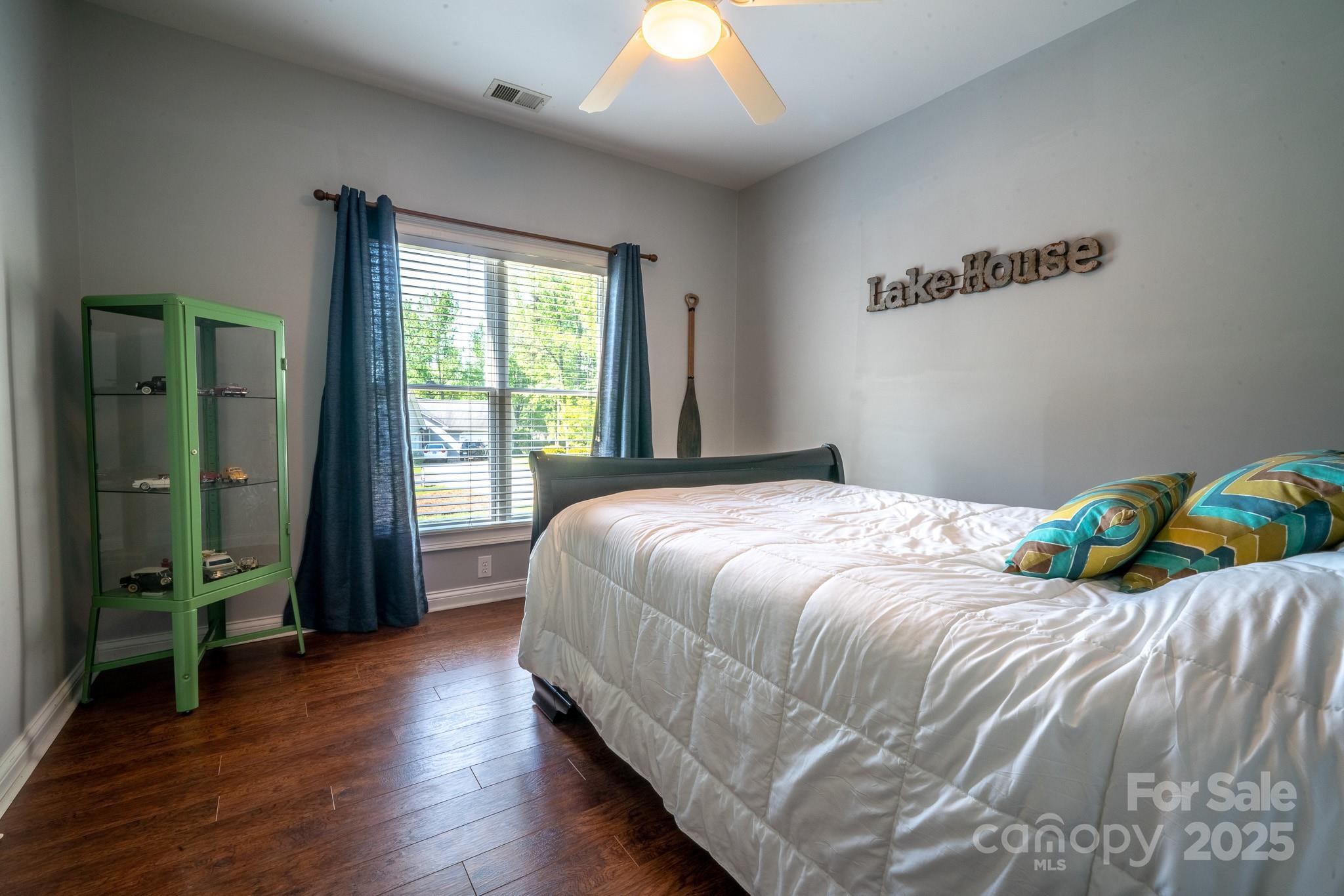 8271 Camelia Lane Denver, NC 28037 - Photo 16 of 27 a bedroom with a bed and a large window