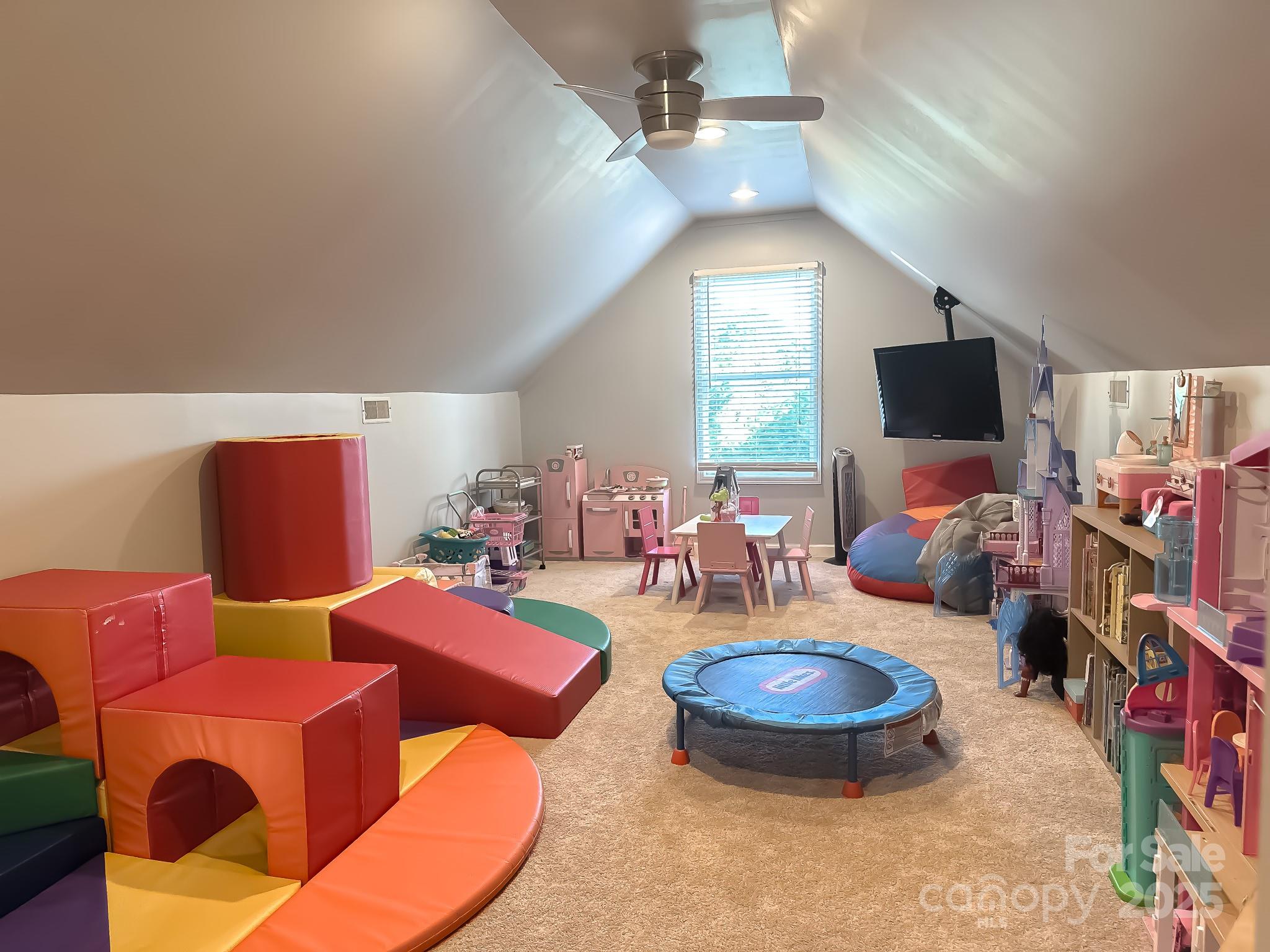 8271 Camelia Lane Denver, NC 28037 - Photo 18 of 27 a living room with furniture a flat screen tv and a chandelier