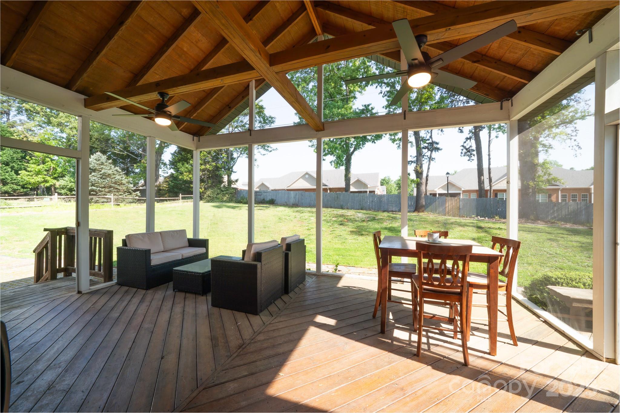 8271 Camelia Lane Denver, NC 28037 - Photo 19 of 27 a view of a patio with lawn chairs floor to ceiling window with wooden floor
