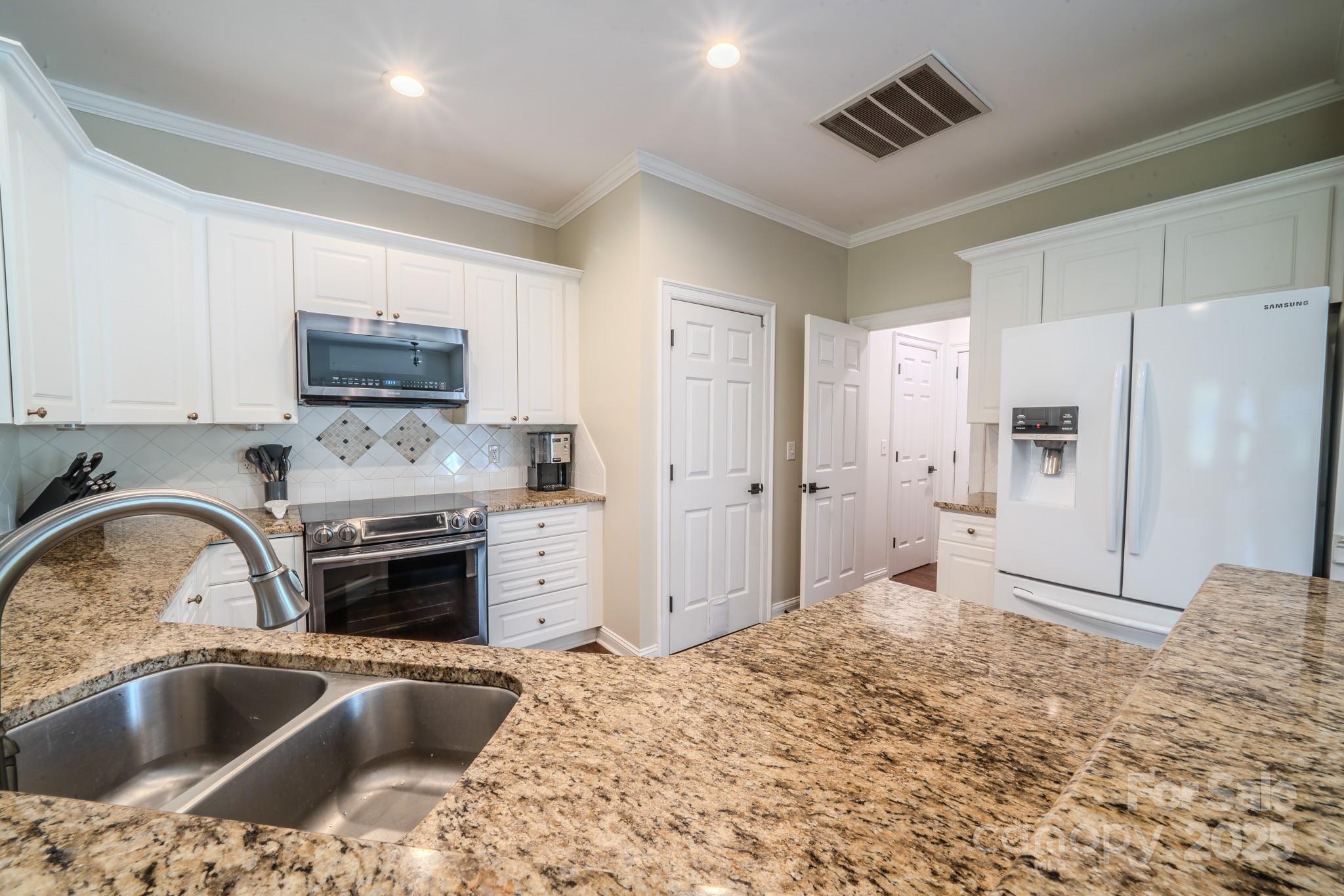 8271 Camelia Lane Denver, NC 28037 - Photo 10 of 27 a kitchen with granite countertop a refrigerator and a sink