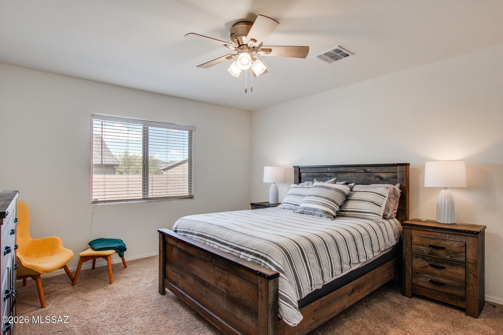7056 South Draper Road Tucson, AZ 85757 - Photo 17 of 22 a bedroom with a bed and a chandelier