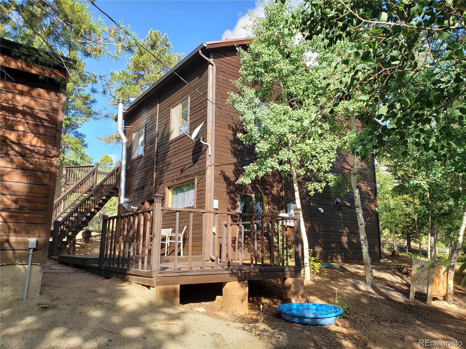 75 West Crosscut Road Bailey, CO 80421 - Photo 11 of 22 a view of a house with a yard
