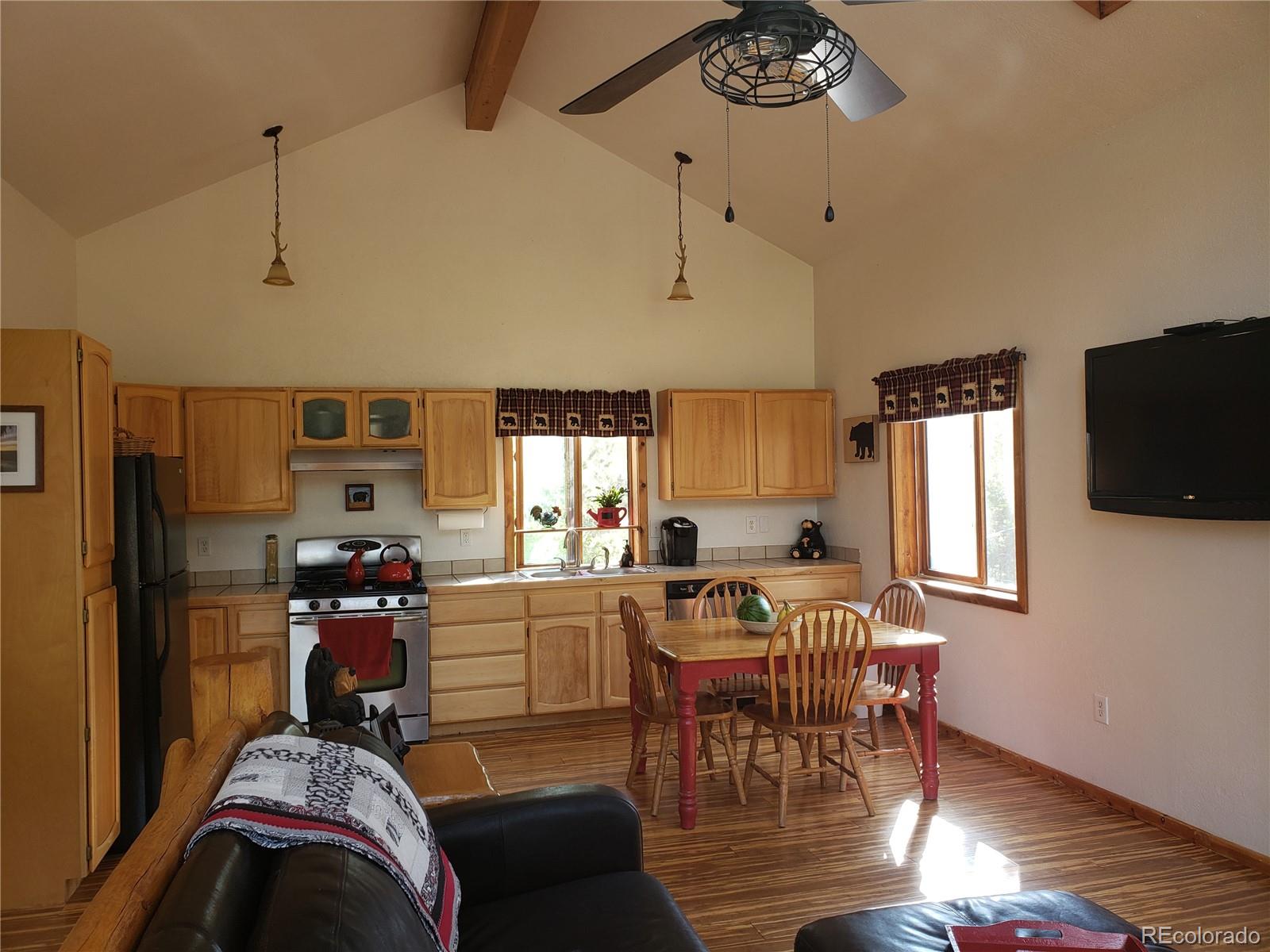 75 West Crosscut Road Bailey, CO 80421 - Photo 3 of 22 a view of a dining room with furniture window and wooden floor