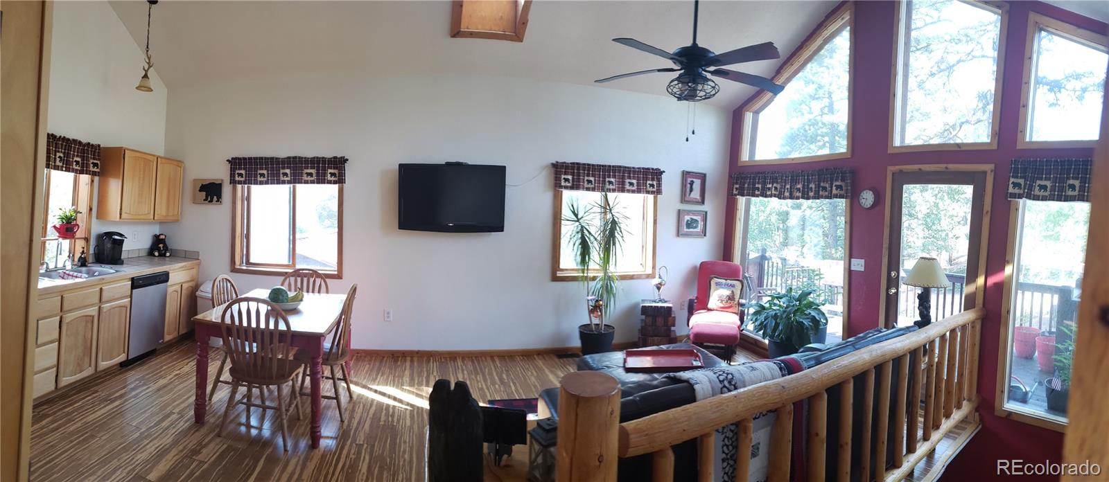 75 West Crosscut Road Bailey, CO 80421 - Photo 4 of 22 a dining room with furniture a chandelier and wooden floor