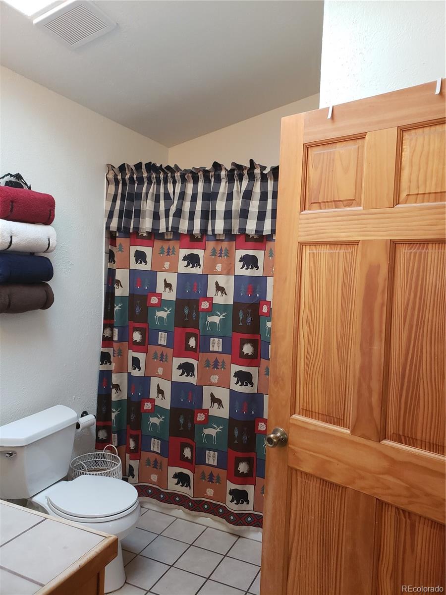 75 West Crosscut Road Bailey, CO 80421 - Photo 6 of 22 a table and chairs in a room