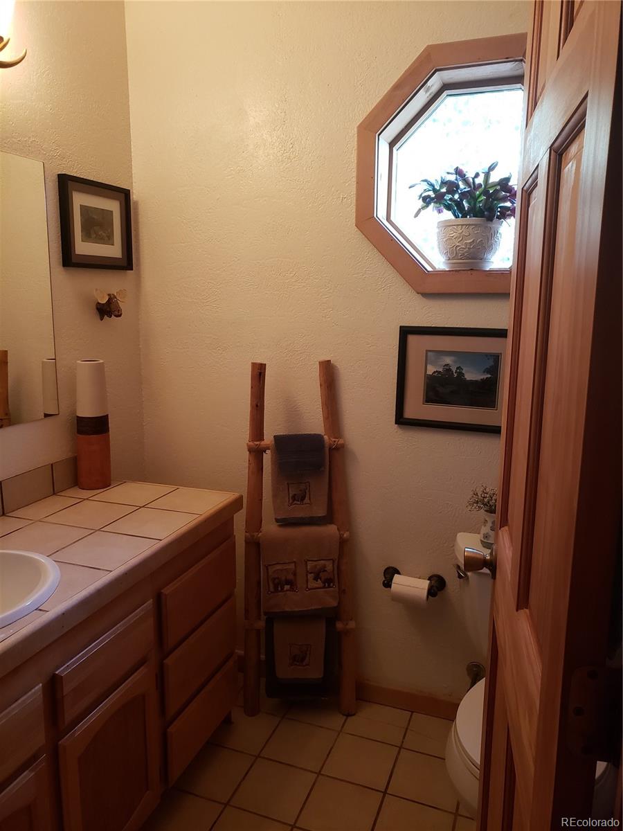 75 West Crosscut Road Bailey, CO 80421 - Photo 9 of 22 a bathroom with a sink and a mirror