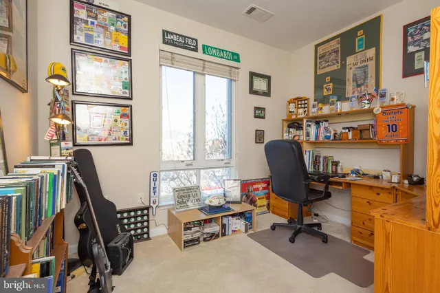 a view of a workspace with furniture and a window