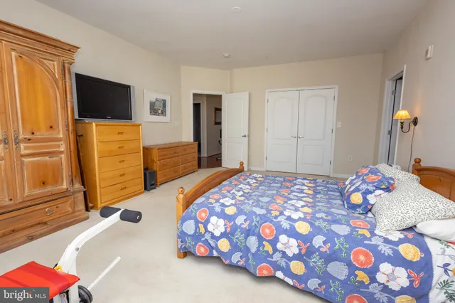 a bedroom with a bed and flat screen tv