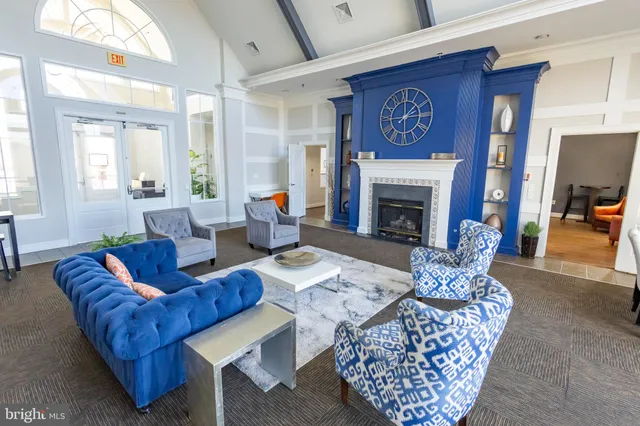 a living room with furniture a fireplace and a large window