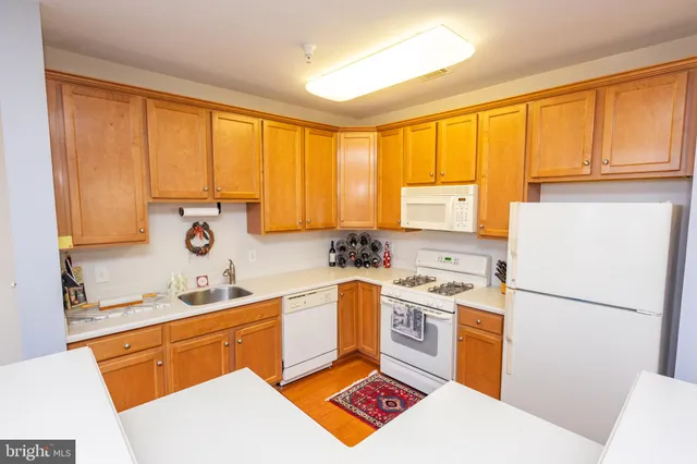 a kitchen with a sink appliances and cabinets